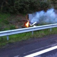 a blurry photo of a road tax camera on fire