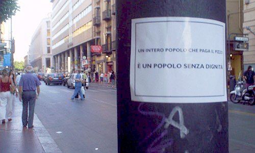 A poster from Palermo reads: “Un intero popolo che paga il pizzo è un popolo senza dignità”